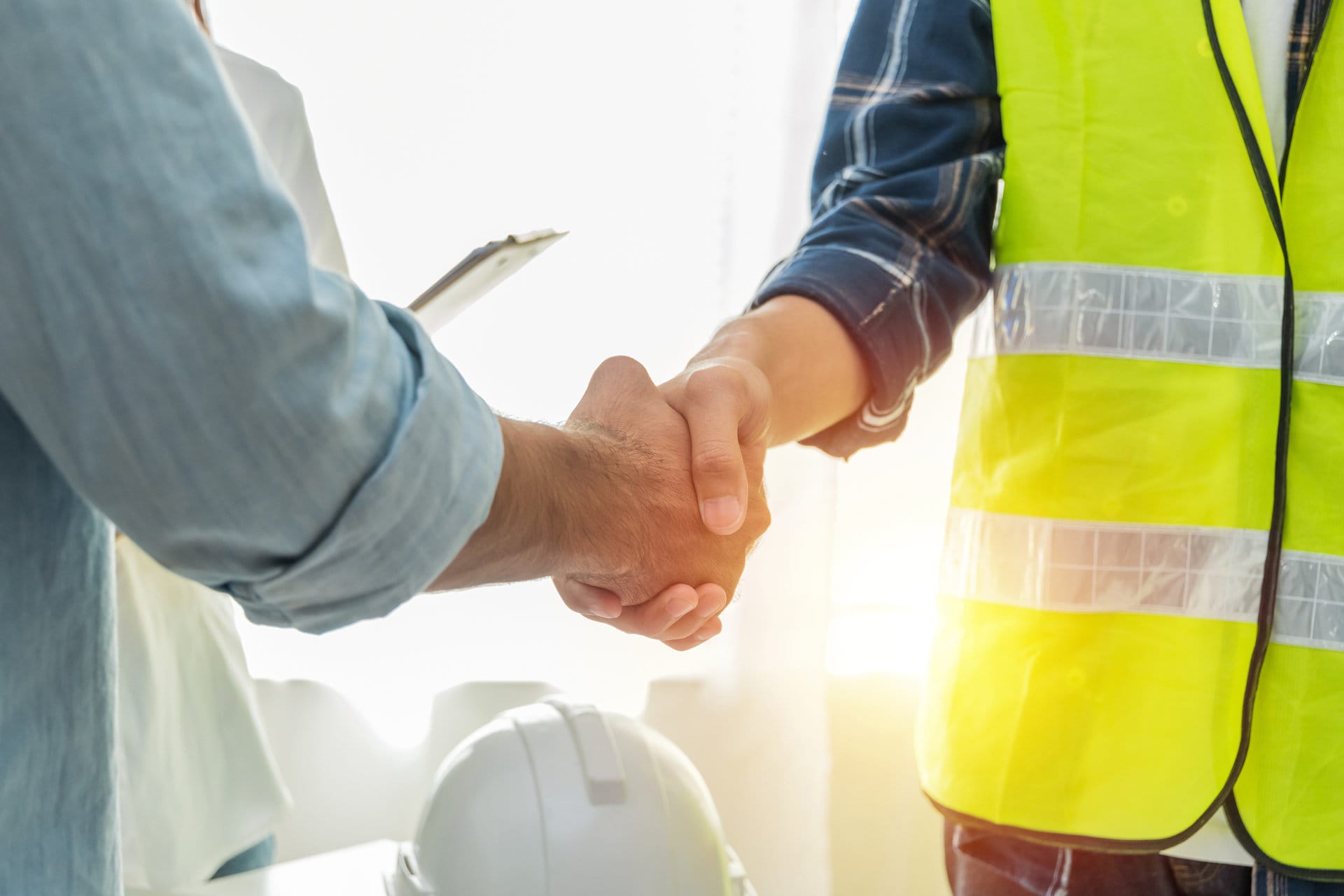 man and construction worker shaking hands